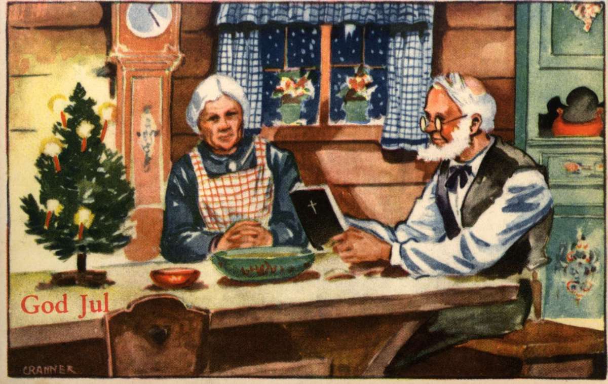 Julekort. Ubrukt. Et eldre ektepar sitter ved bordet i en julepyntet stue. 
Mannen leser i bibelen. Illustrert av Birger Cranner (1902-1945).