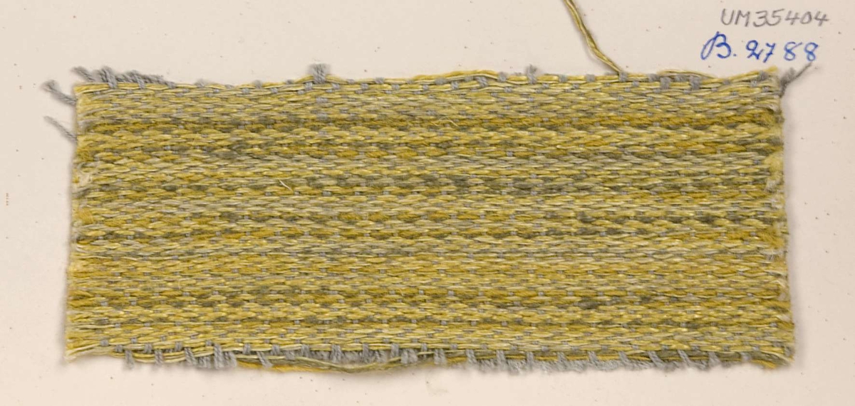 Vävprov ämnat för möbeltyg vävt med bomulls, ull- och lingarn, gulgrått. Vävprovet har nummer "B-2788".
