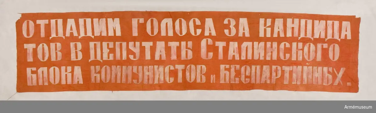 Grupp M V
Av rött tyg med text på ryska.