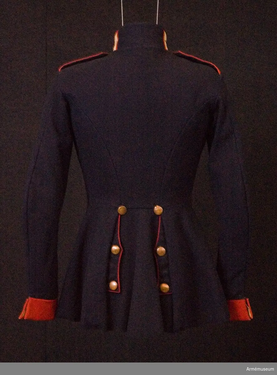 Grupp C.
Ur uniform för manskap, Landwehrsoffizier, Feldvebel, vid 2:a Gardesregementet, Preussen. Fastställt år 1843.
Av mörkblått kläde. Åtsittande med tvärsöm i midjan. Rocken är enradig med åtta knappar. På båda bakfickorna ett tvåuddigt lock med tre knappar. Axelklaffar av rött tyg, med mörkblått tyg under. Längd 14 cm och bredd 6 cm. Axelklaffarna är fastsydda vid ärmsömmarna och fästade vid rocken med knappar. Nr "1" kompaninummer. Foder av grov linne- lärft på övre delen. Nedre delens foder är av svart grovt satängtyg. Knapparna är gjorda av koppar, 2 cm i diameter. På bröstet, på fickorna och ärmuppslagen knappar av större format, på axlarna knappar av mindre format med kompaninummer. Kragen är upprättstående med raka vinklar av rött tyg med blå passpoal på kragens överkant. Kragen har har på båda sidor två knapphål -1 cm breda- av bomullsband- -beteckning för gardesregemente- samt tre hyskor och hakar. Kragen är fodrad med mörkblått tyg. Röda passpoaler längs rockens främre kant och de bakre fickorna lock. Ärmuppslag -svensk modell- rakskurna av rött tyg 6 cm  höga med två knapphål av vita bomullsband, 5,5 cm långa och 2 cm breda.
LITT  Uniformenkunde, R. Knötel. album. Preussen. Uniform för 2:a Gardesregementet till fots år 1843. Färgbild. Geschichte der Bekliedung und Ausrüstning der königlichen Preussischen Armée in den jahren 1808 bis 1878, Berlin. Sid 3 paragraf 572. Vapenrocken (m/1843) infördes oktober 1842. Das Deutsche Reichsheer. G.Krickel. Sid 11. Det 2:a Gardesregementet till  fots fick svenska ärmuppslag i stället för brandenburgska enligt dagorder av den 18 januari 1834. Uniformenkunde das Deutsche Heer. R.Knötel IV:e textvolym. sid 28. Regementet grundades år 1813.
Vapenrocken har en pappersetikett, där det står: "Vapenrock, Preussisk modell. Avlämnad år 1845 till kungl. krigs-Collegium av överst-leut. Söderberg".