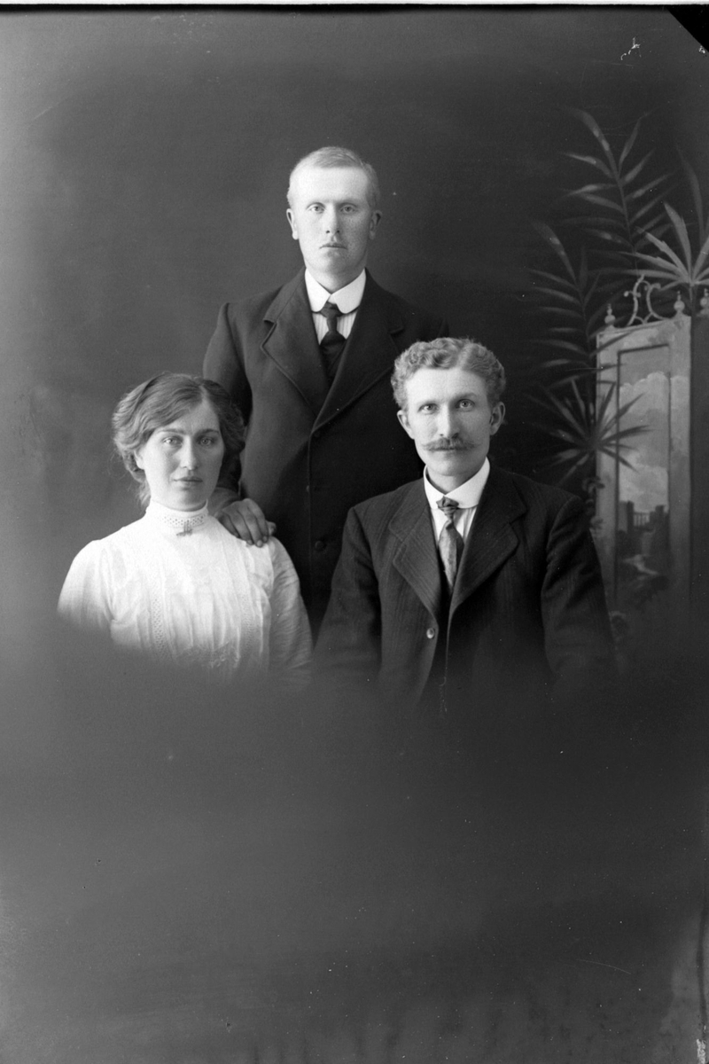 Studioportrett av tre personer i halvfigur.