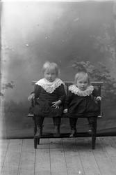 Studioportrett av to søstre.