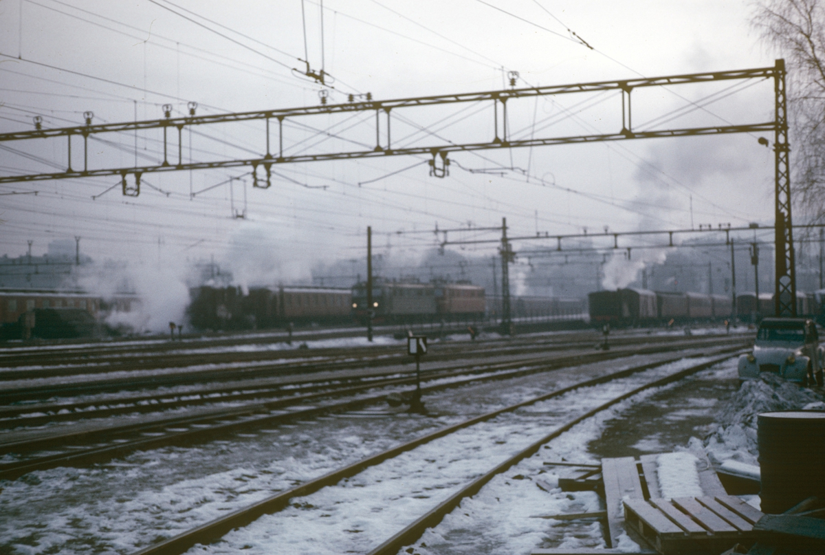 Damplokomotiver type 23b på Oslo Østbanestasjon. Elektrisk lokomotiv El 13 midt på bildet