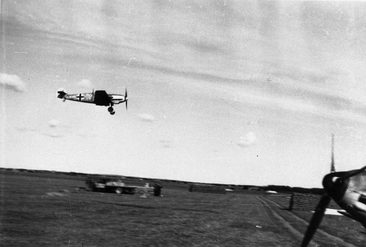 Lufthavn, tysk militert  fly i luften og flere fly på bakken Bf109