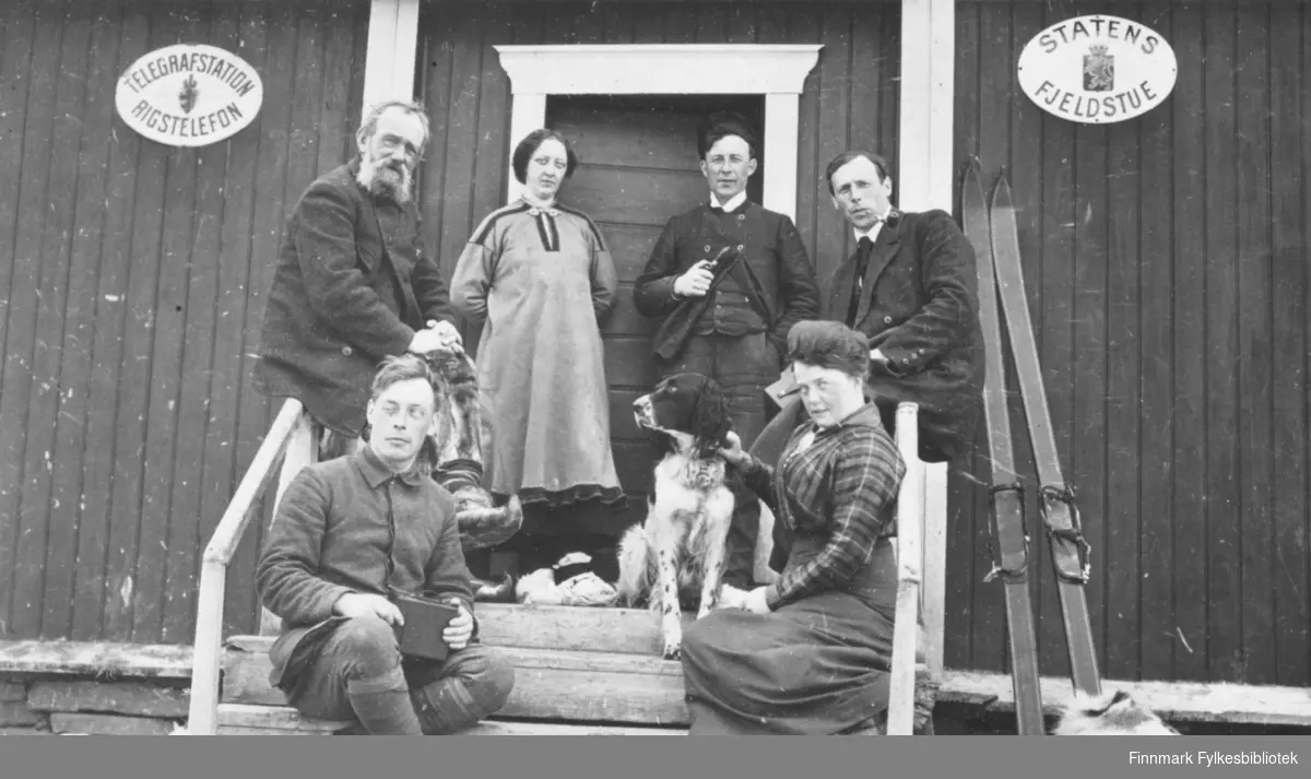 På trappa til Levajok fjellstue, skjærtorsdag i 1916. Til venstre foran: Hans Gabrielsen. Kvinnen med hund er Signe Solem