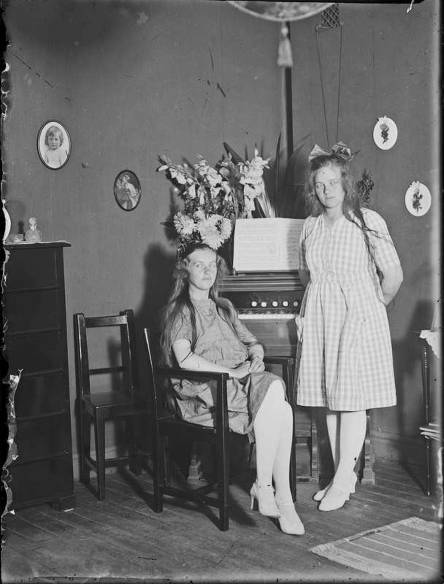 Två unga flickor vid en orgel.