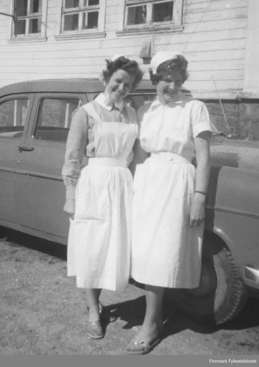 Sykepleierne Agnes Kristiansen og Jorunn Stock fotografert utenfor Vadsø sykehus, 1959
