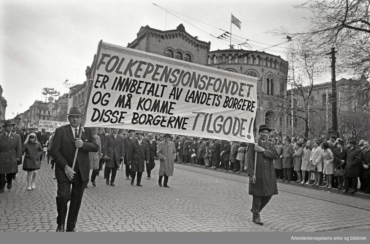 1. mai 1968 i Oslo.Demonstrasjonstoget i Karl Johans gate.Parole: Folkepensjonsfondet er innbetalt av landets borgere og må komme disse borgerne tilgode!.