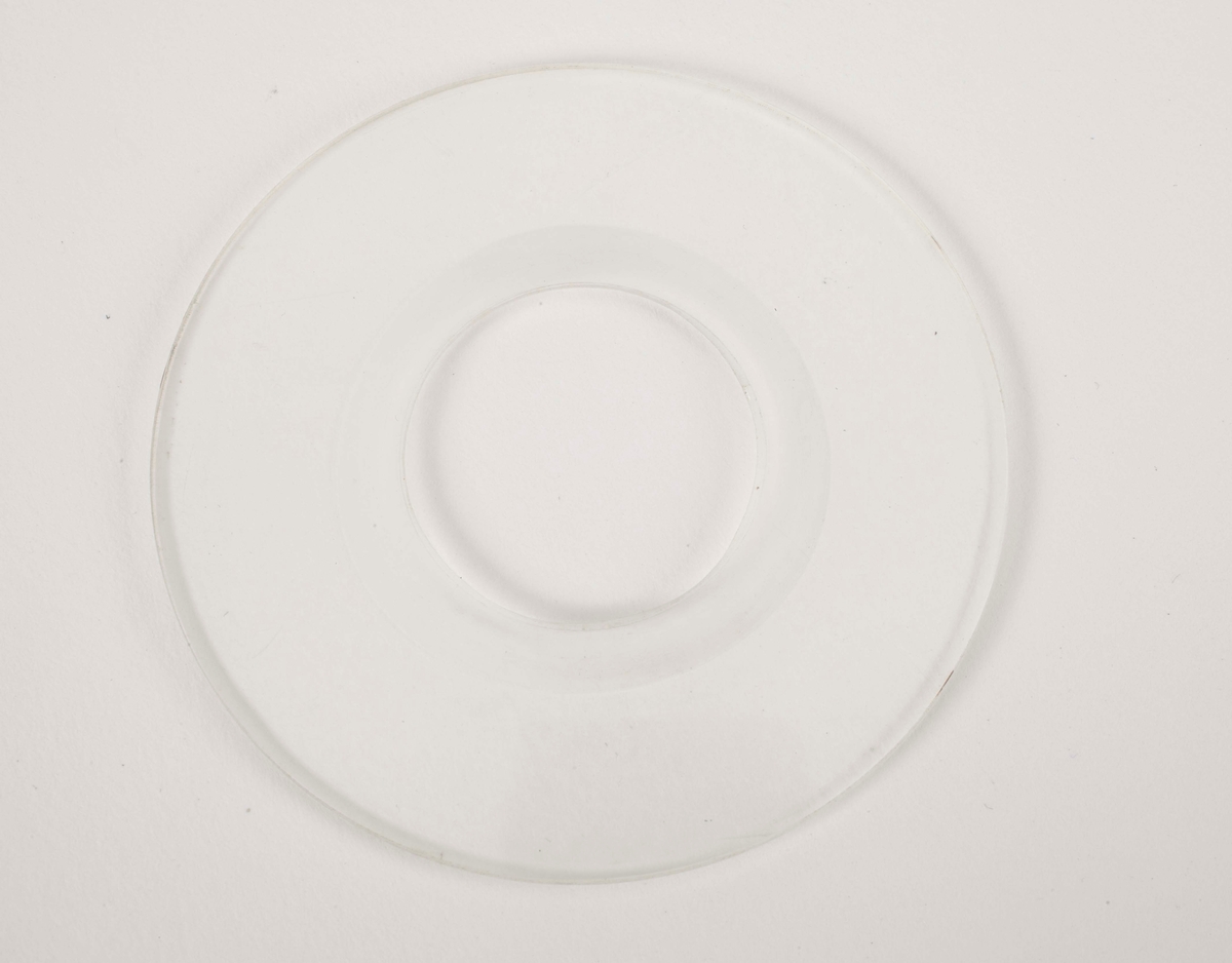 En rund plastskive med ett hull i midten.