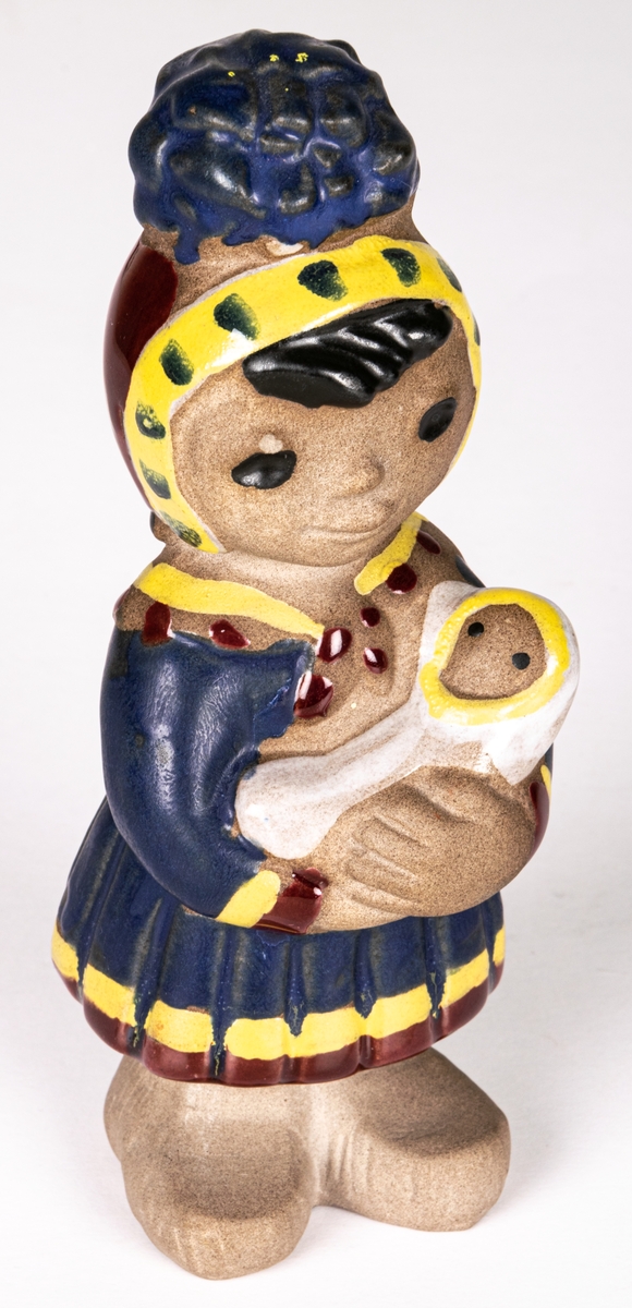 Figurin Lappflicka, formgiven av Dorothy Clough 1955 för Gefle Porslinsfabrik. Hör samman med figurinerna Lappojke och Lapphund.