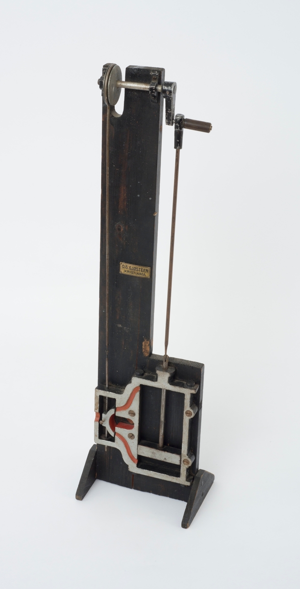 Apparat som viser et stempel og drivverk i en dampmaskin.