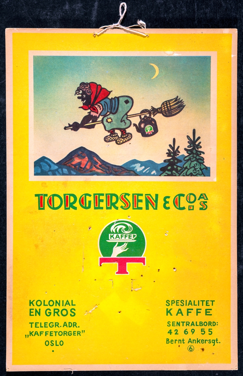 Reklamemateriell. Bakgrunnsplate av papp til avrivingskalender. Gul bakgrunnsfarge. Flerfarget tegning av heks på kost. Tekst i grønt og rødt: "TORGERSEN & CO A/S".
