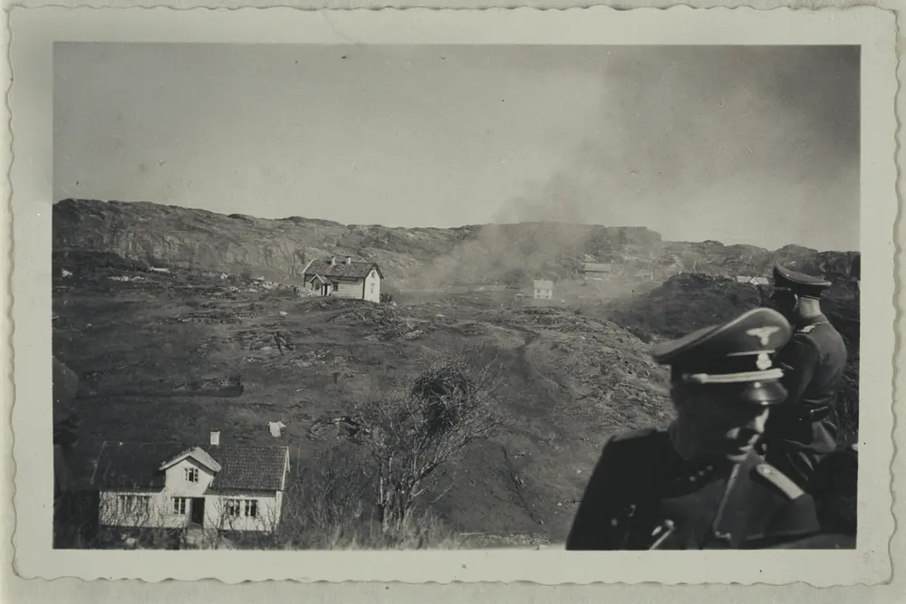 Smoke rising from ruins of Morten Nipen`s house.