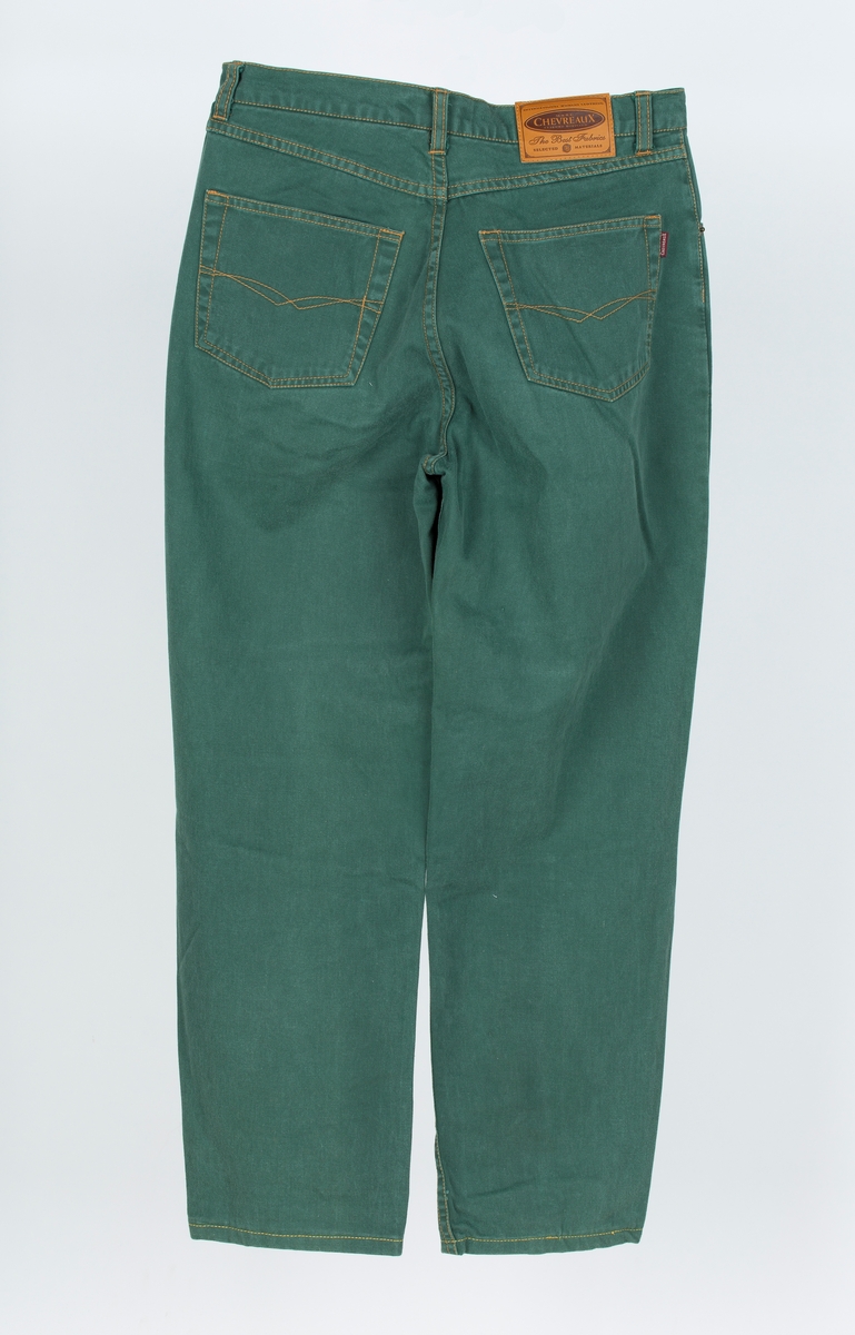 Bukse, Jeans. . 5 lommer, rette ben. Grønn, gule stikninger.
Fritidsbruk. Kjøpt hos Ellos, Postordre.