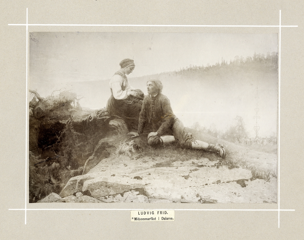 Avfotograferad tavla av Ludvig Frid, "Midsommarfäst i Dalarne".
En kvinna och en man sitter och samtalar i ett landskap.