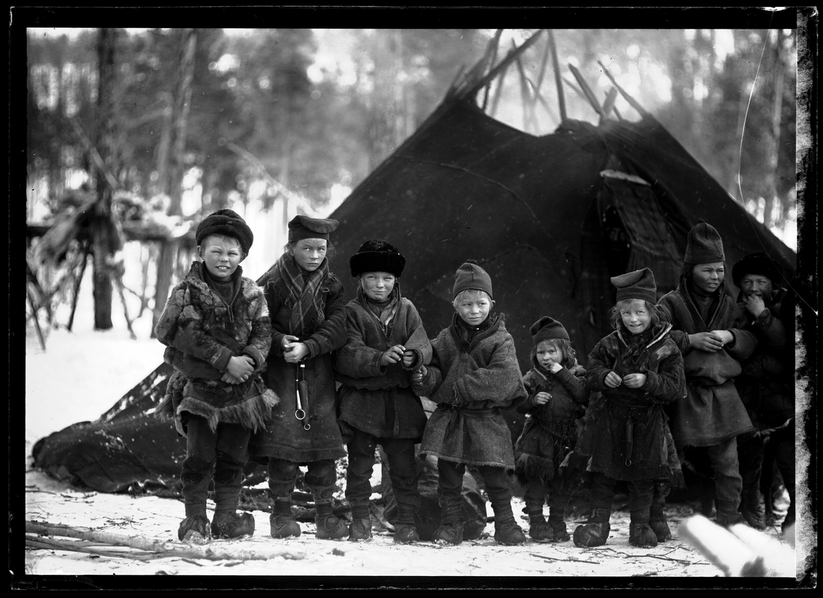 Nomadskola. Samiska skolbarn samlade utanför tältkåta. Gällivare socken, Lule lappmark, Norrbotten.