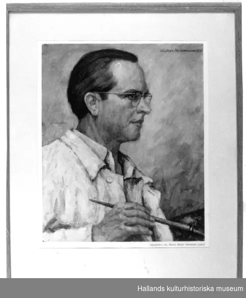 Färgreproduktion. Ett självporträtt i profil. Mannen bär glasögon. Träram, 1 cm bred. Metalltråd för upphängning på baksidan. Glas. Märkt: "Selbstbildnis des Malers Walter Hartmann (1952)".