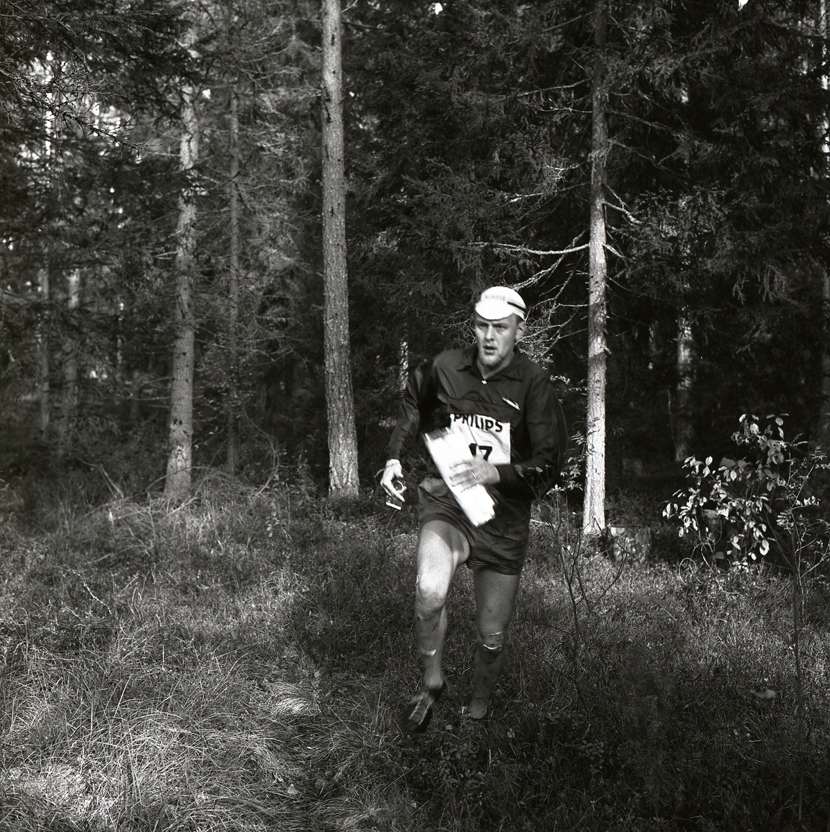En deltagare springer i skogen under svenska mästerskapen i orientering hösten 1965 i Segersta.