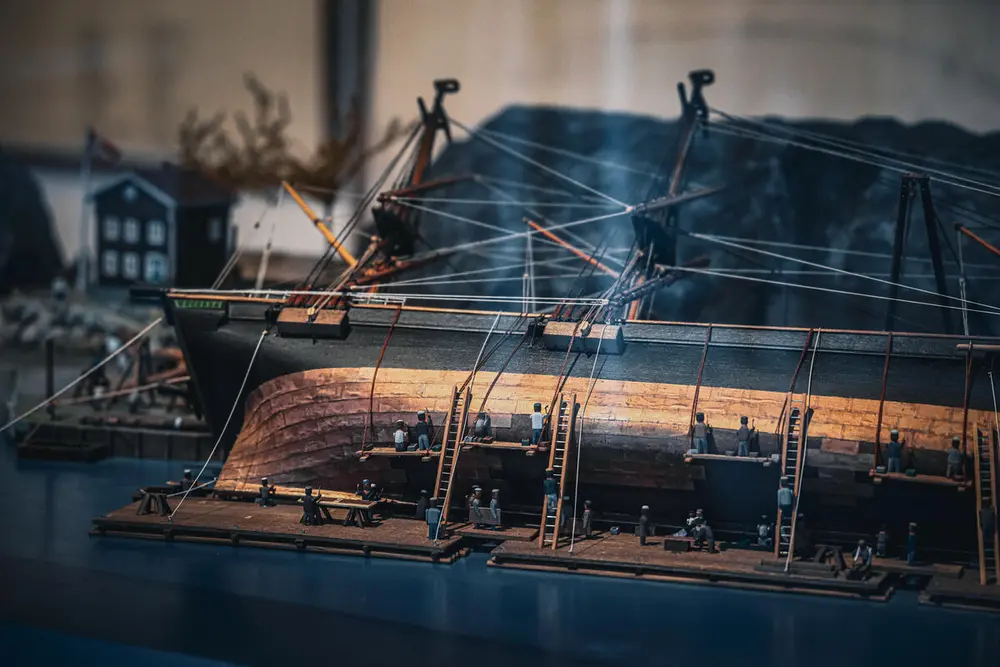 A segment of a model showing careening at a careening yard in Bergen. Ships were careened, that is, pulled onto their sides, to perform repair work below the waterline.