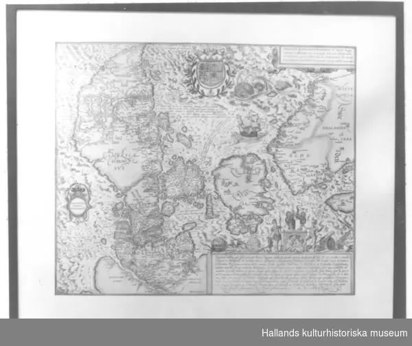 Karta, tavla. Kopia, nytryck. a) Karta över Danmark från 1585. Rektangulär. Akvarellerad. Glasad.Dagermått: bredd: 58,8 cm, höjd: 49,2 cm. b) Ram av trä. Bredd: 2 cm.