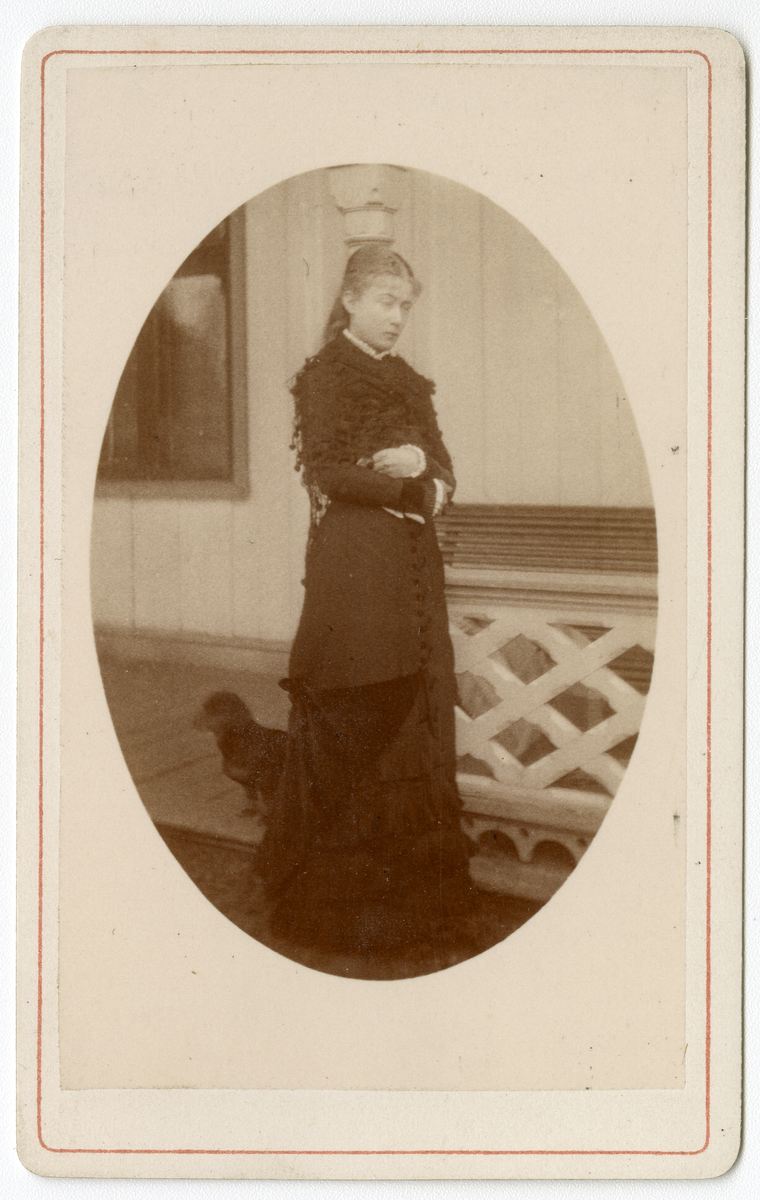 Foto av fru Elsa Rieck født Fuhr, trolig en gang på tidlig 1880-tallet. En hund titter fram bak henne