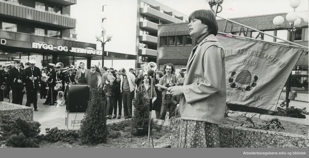 1. mai 1980, i Oslo. Tekst på avisklipp bakpå bildet: Kommunalrådsekretær Siri Bjerke talte under morgenapellen i Tøyen senter 1. mai. Kampen janitsjarorkester spilte Internationalen.