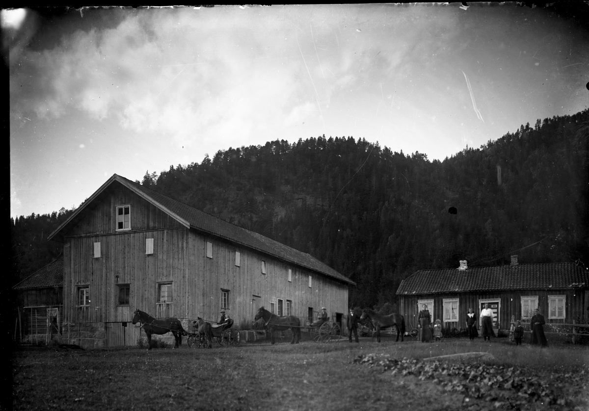 Gårdsmotiv. Familie foran hus 

Fotosamling etter fotograf og skogsarbeider Ole Romsdalen (f. 23.02.1893).