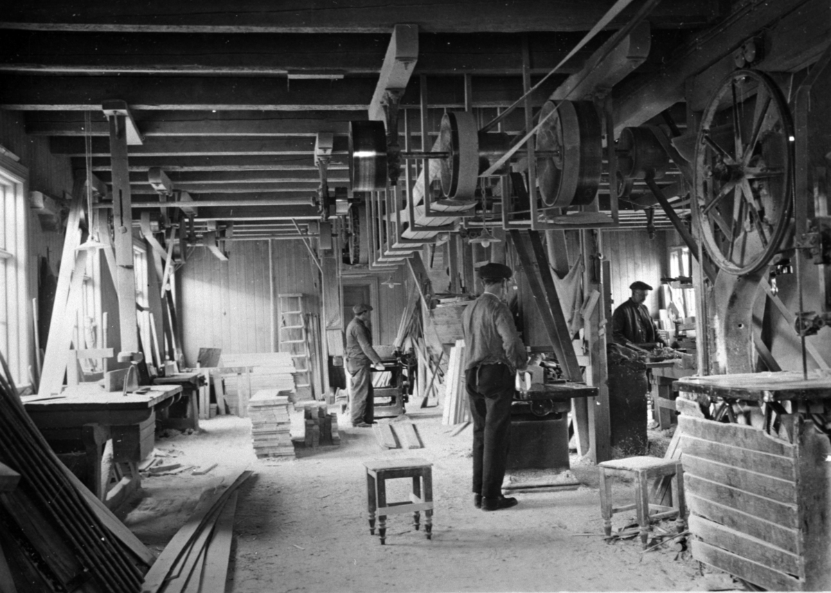 Interiør, snekkerverksted, O. Johansens trevarefabrikk, Moelv. Foran er Dalseth, til høyre er Simensen. Sag og pussemaskiner med removerføring.