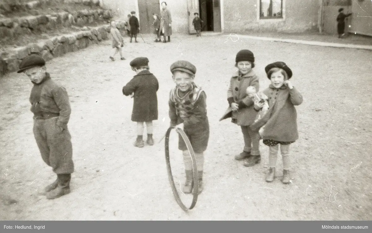 Bosgårdens barnträdgård 1939. Leif, Lille Göte, Göte med tunnband, Kicka och Mona leker utomhus.