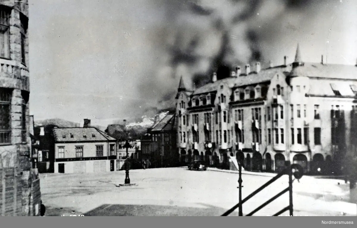 Postkort med tekst:  ";Torvet 28. april 1940.  Kristiansund."; Brannen nærmer seg.  (Fra Nordmøre Museums fotosamlinger.) /Reg:EFR2013/



