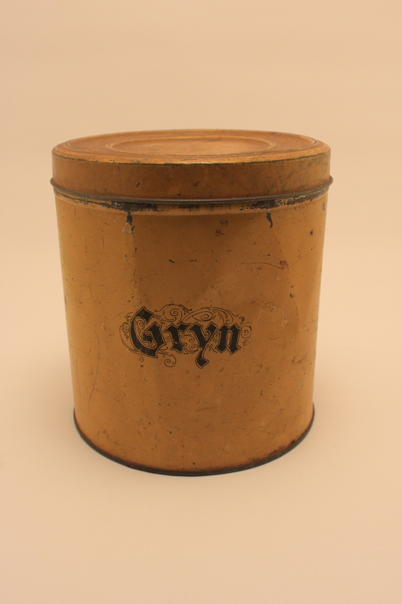 Gul cylindrisk plåtburk med lock för Gryn.