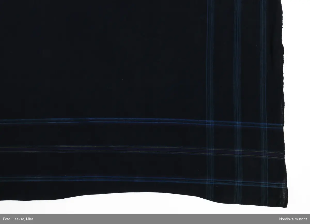 Kvadratiskt huvudkläde av mörkblå bomullslärft med 3 kantbårder i ljusare blått , längs 2 av sidorna även med något lila och gult..
Handvävt. Fint handsydda fållar på 2 sidor, stadkant på 2
I gott skick.
/Berit Eldvik 2012-01-02