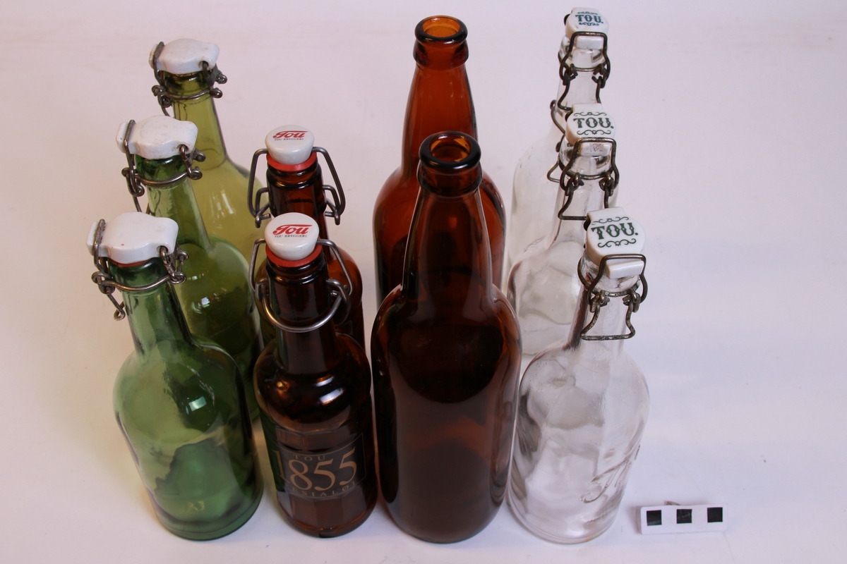 10 tomme ølflasker av ulike typer:
2 store Tou 0,75l (a)
3 klare Tou med hengsla kork, utan pakning (b)
2 brune Tou 0,35l med hengsla kork, med pakning (c)
3 grøne med hengsla kork, utan pakning (d)