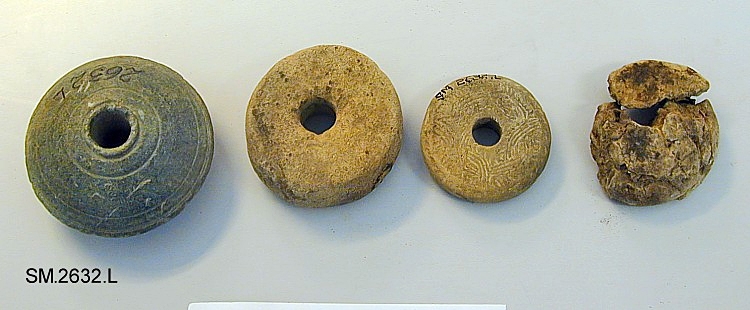 Fra protokollen (J. S. Munch): 4 spinnehjul
Under dette nr (2632.L-1) er:
Spinnehjul av brent leire. Skiveformet, 4 cm i tverrmål og 1,5 cm høyt. Uten dekor.

Disse saker (SM.2632.A-M) er funnet samlet i en gravhaug av langstrakt form, 20 fot lang, omgitt av en grøft. I haugen var 3 brannsteder, mellom dem lå sakene. Noen forrustete jernfragmenter ligger også ved funnet. 
Datering: Yngre romertid eller overgangen til folkevandringstid.