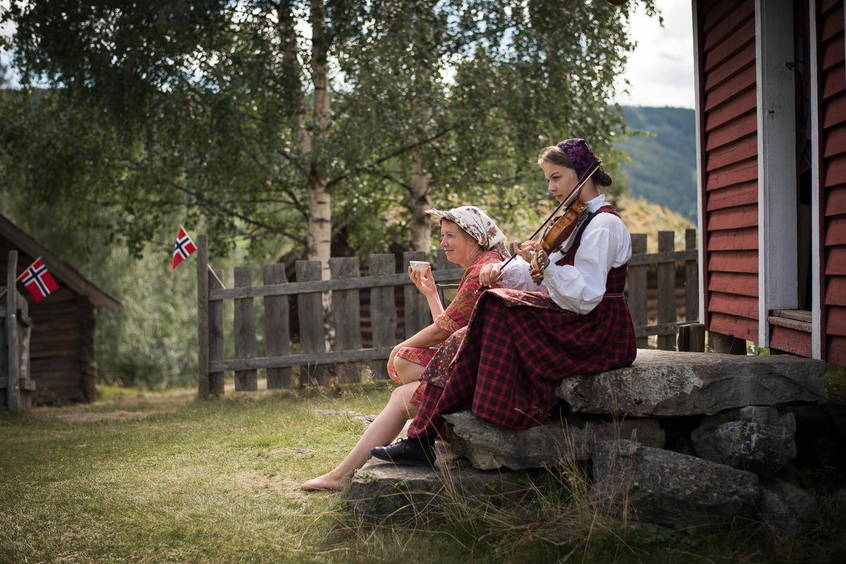 to kvinner på stølen, en spiller fele