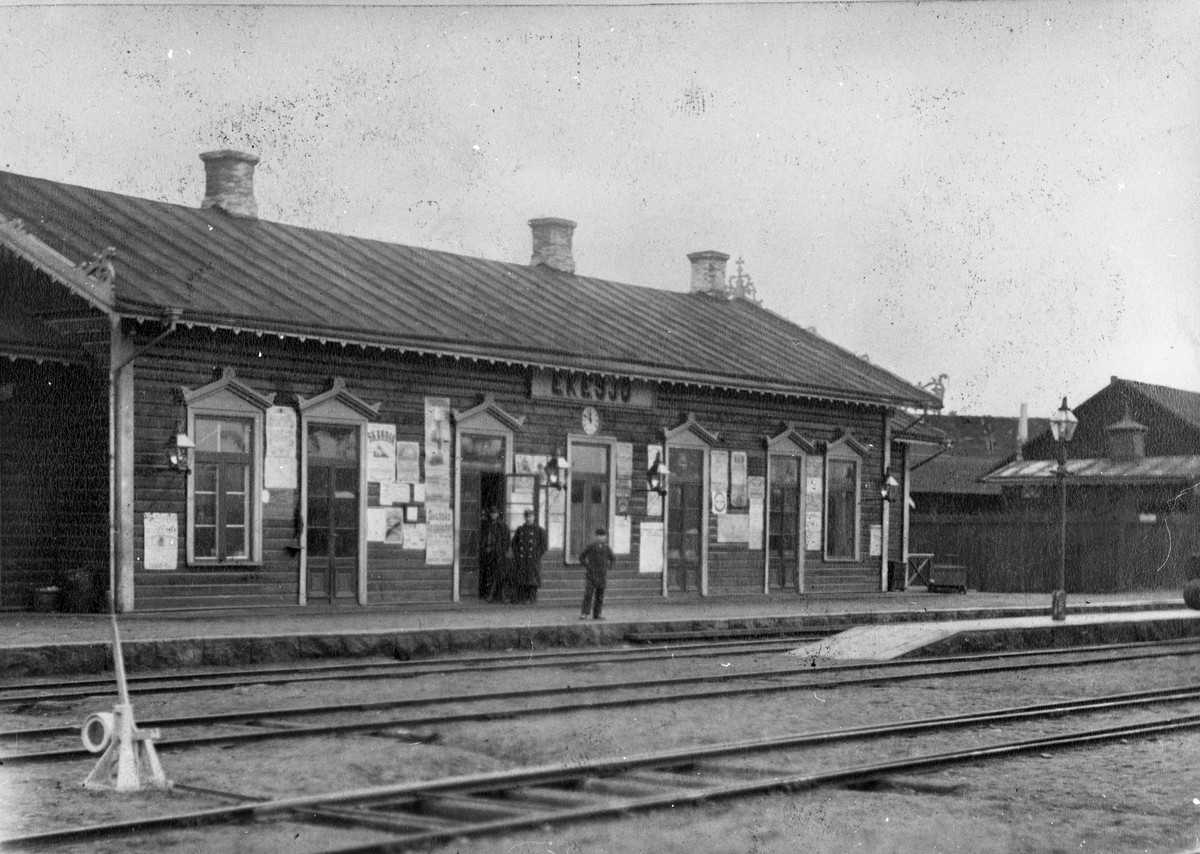 Eksjö gamla stationshus från 1873,  då hette stationen Ekesjö. Mannen i uniform vid dörren är troligen stationsföreståndare U E L Swensson.

Reklam: Skandia; Svenska Dagbladet.