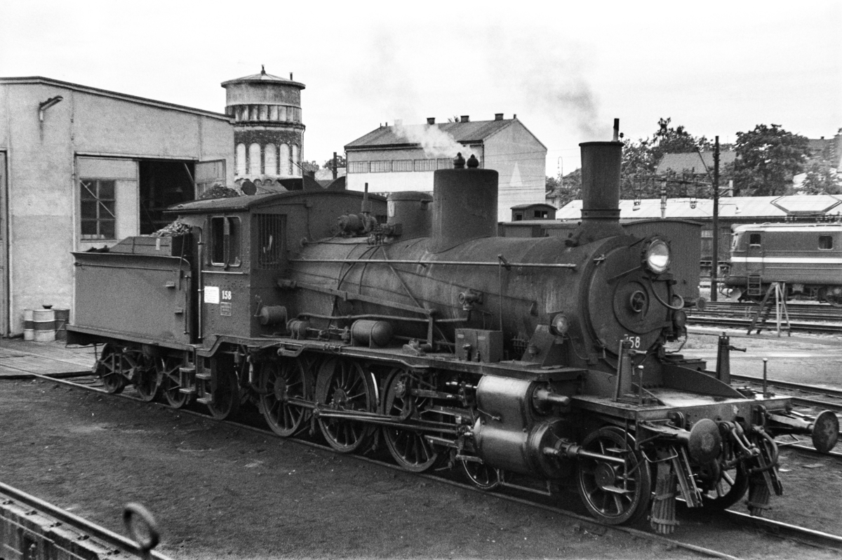 Damplokomotiv type 18c nr. 158 foran lokstallen på Hamar stasjon.