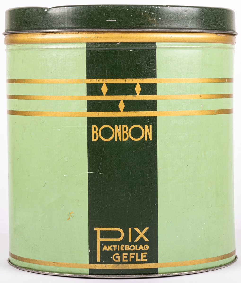 Plåtburk för bonbon-karameller. Två nyanser av grönt med gulddekor. Sannolikt från 1930-talet. Stildrag av art deco och funkis.