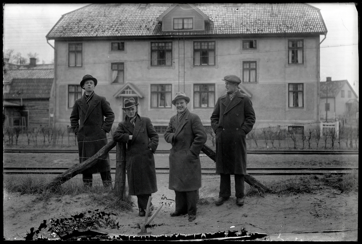 Fyra män framför järvägsspår
