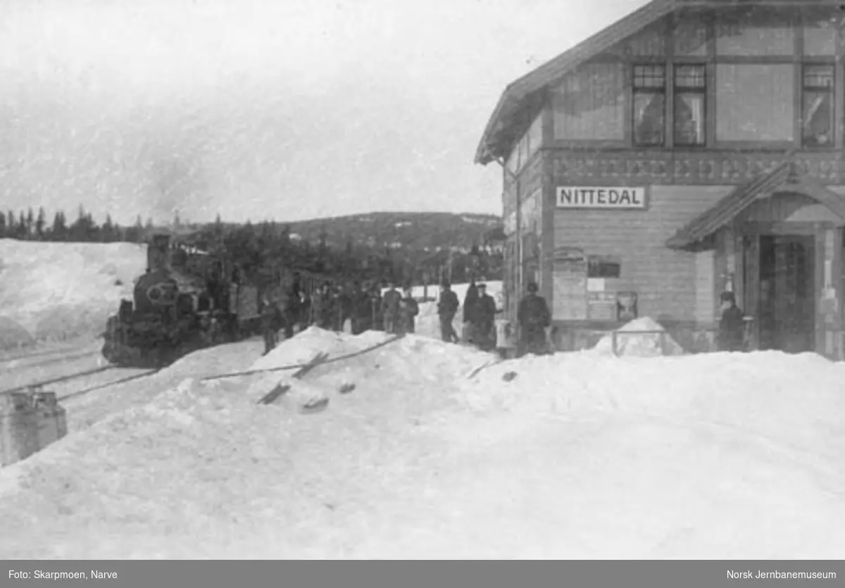 Nittedal stasjon med skiløpere på plattformen og ankommende tog