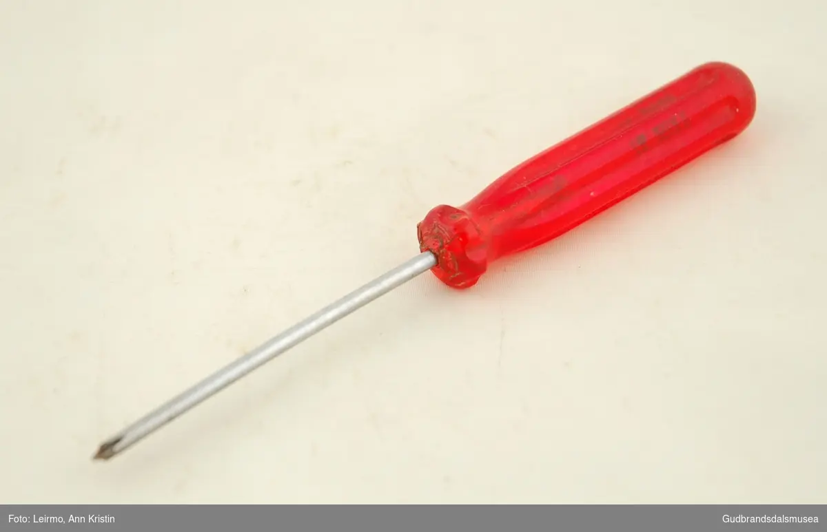 Lite stjerneskrujern Geilo-verktøy, i chrom vanadium, med håndtak i rød hardplast. Metall tappet i håndtak.