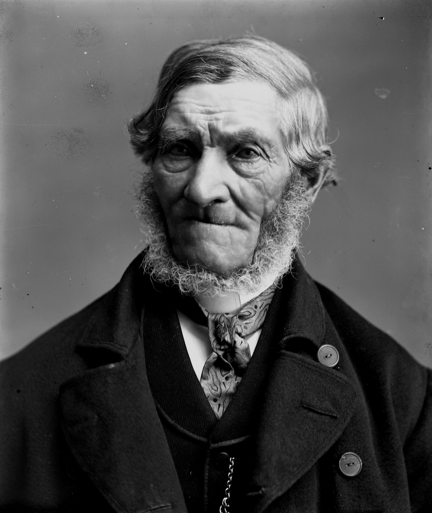 En äldre man.
Smeden Carl Petter Persson, född 1812-11-06 vid Boka ägor i Hällestad, död 1896-03-12 i Regna. Han var gift med Maja Stina Andersdotter Snöberg. Han var Aron Hallbergs styvfar.