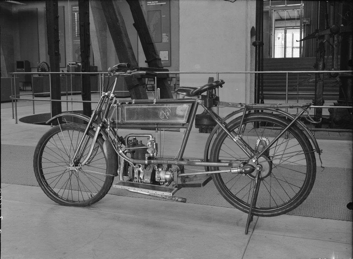 Årsmodell 1910 eller 1911 och delvis ombyggd, "moderniserad", då bl.a. fotplattorna tillkom. Kraftöverföring med kardan. Start sker genom att bakhjulet sätts upp stödet, därefter vevar man vid kedjan som går till baknavet tills motorn startar.  Encylindrig bensinmotor, cylindervolym 247 cc 2 1/4 hk Förgasare: Zenith Magnettändning till tändstift Däckdimension: Vulst 26x2