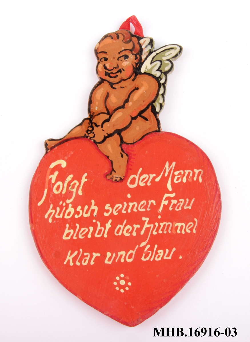 Treskilt med engel sittende på et hjerte. Ordtak eller leveregel på tysk.
