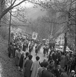 Tog med korps og faner ver kirkesvingen.