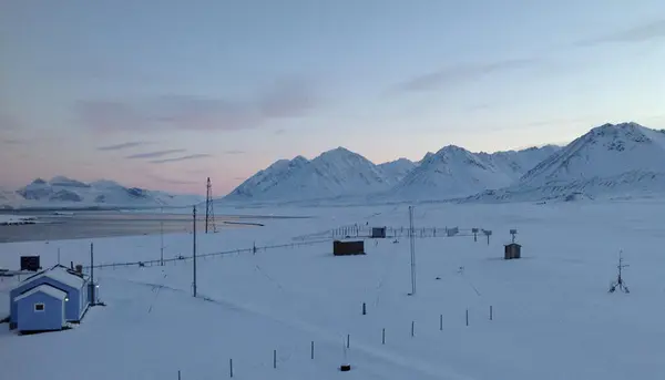 Blått fredet hus med fjell på Svalbard