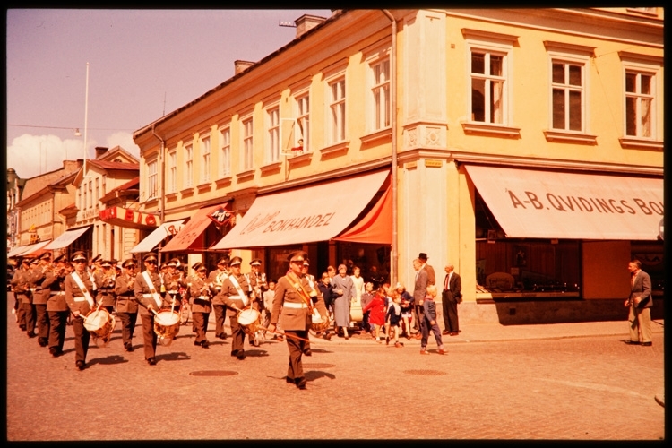 Kronobergs regementes musikkår utanför Quidings bokhandel, 1956. Hörnet Storgatan och Klostergatan i Växjö. Storgatan 12, kv. Klostret 5.
