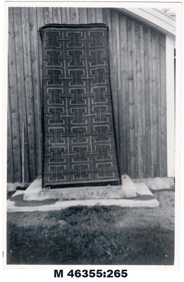 Svartvitt foto av mörk flossamatta med ljusa 
partier.

Inskrivet i huvudbok 1983.
Montering/Ram: Ej ramad