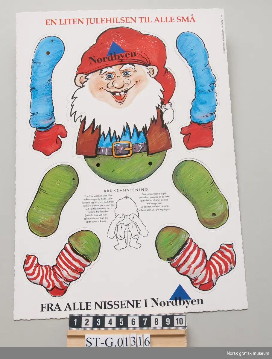 Nisse i syv deler ment for utklipp. Med bruksanvisning. 
Tekst: "En liten julehilsen til alle små. Fra alle nissene i Nordbyen"