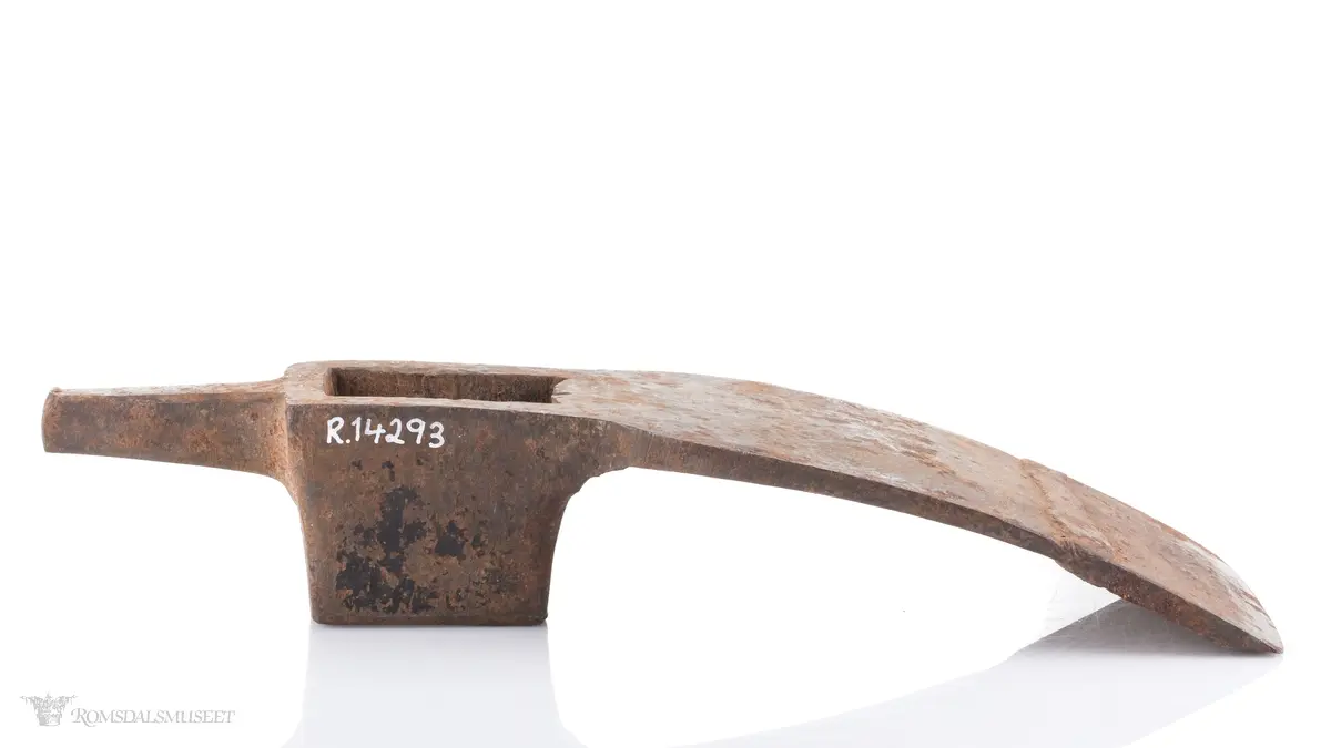 Øksehode med eggen på tvers i forhold til skaftefestet. Rett egg som ser ut til å ha blitt smidd på av bruker. Hammer med firkantet snitt i bakkant av hodet som smalner av mot enden. En tverrøks brukes til å hugge stokker og planker for å jevne ut flater, forme bjelker og takrygger samt ved snekring og båtbygging.